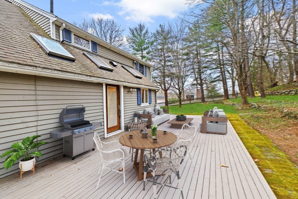 31 Doris Road Braintree, MA 02184 - Photo 19 of 20 a view of a patio with table and chairs with wooden floor and fence