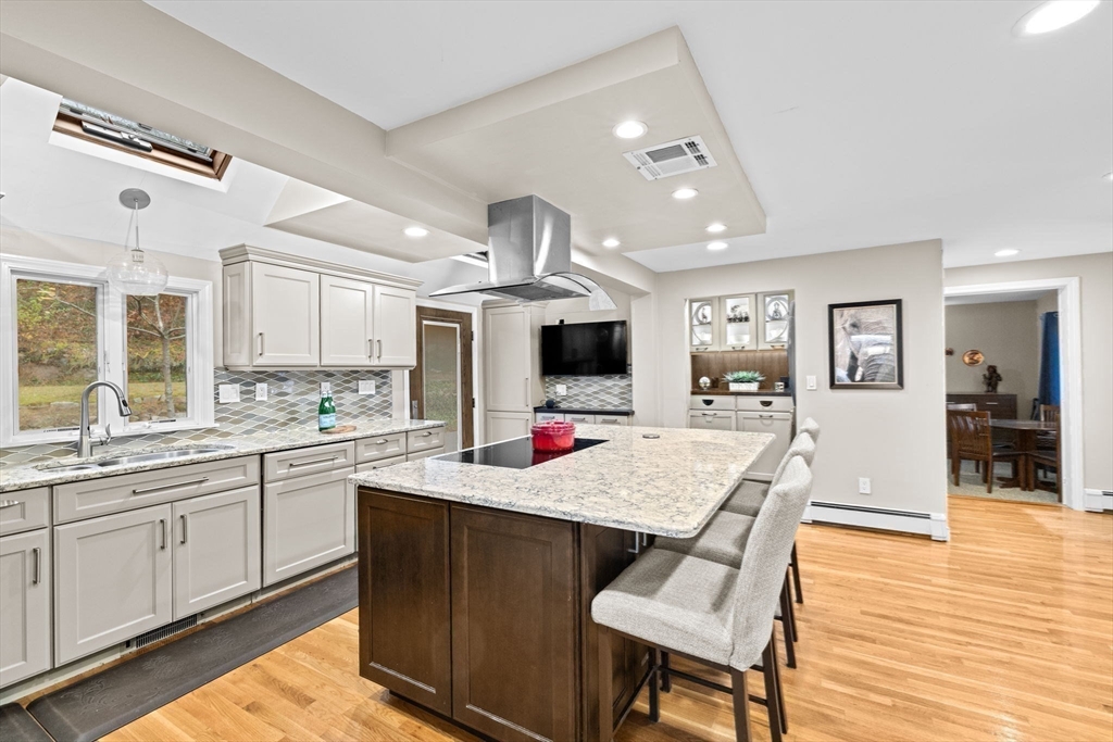 31 Doris Road Braintree, MA 02184 - Photo 4 of 20 a kitchen view with stainless steel appliances kitchen island granite countertop a sink and cabinets