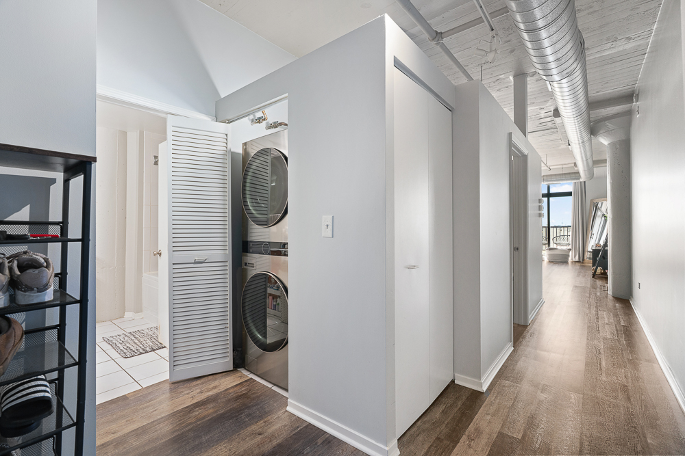 1525 South Sangamon Street, Unit 514 Chicago, IL 60608 - Photo 15 of 16 a view of a hallway with washer and dryer