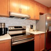 a kitchen with a stove and a refrigerator