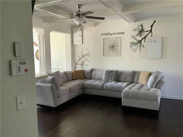 a living room with furniture and a chandelier