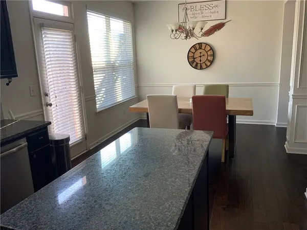 a view of table and chair with wooden floor