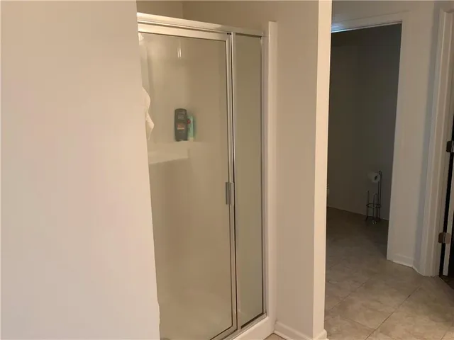 a bathroom with a glass shower door