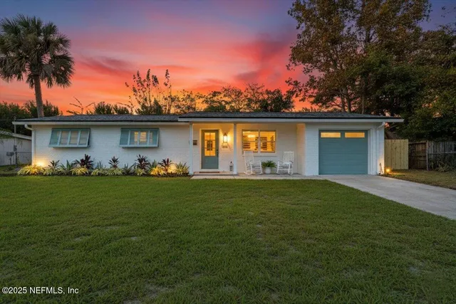 a front view of a house with a garden