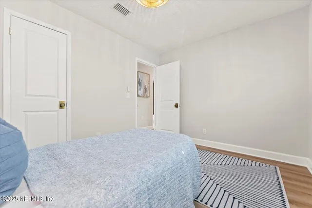 a bathroom with a granite countertop sink mirror vanity and toilet