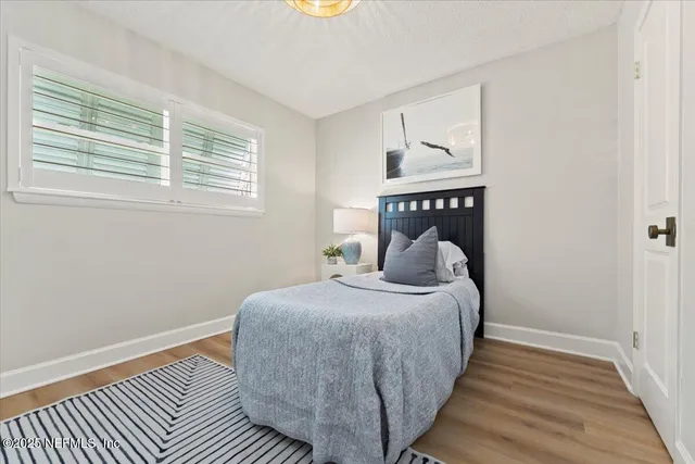a view of a bedroom with furniture and a window
