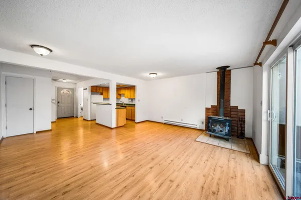 a view of a hallway with wooden floor and furniture