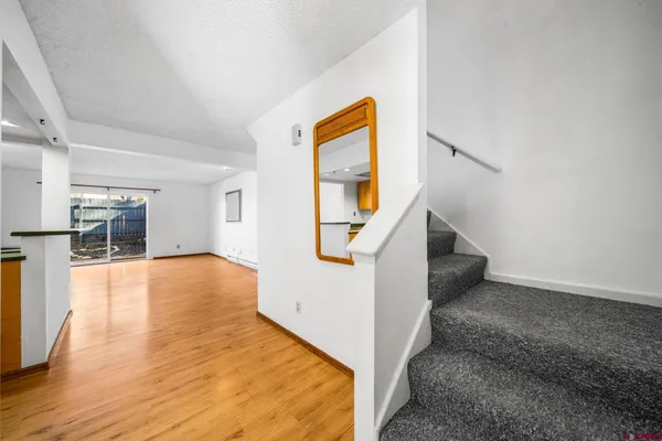 a kitchen with stainless steel appliances a sink cabinets and a large window