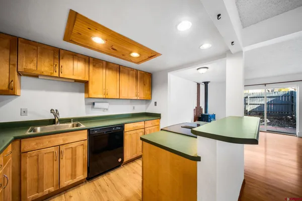 a view of a kitchen with a sink and a large window