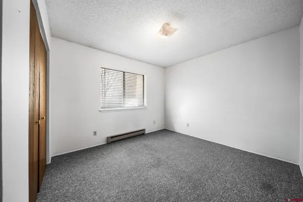 an empty room with a empty space and windows