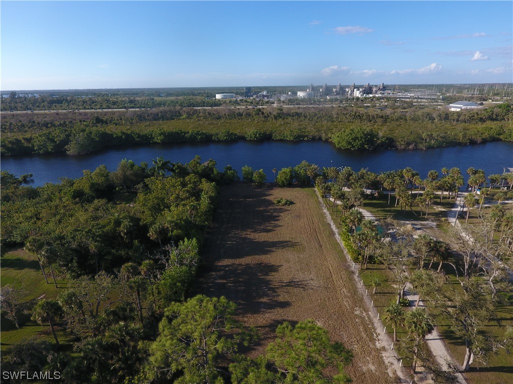 3860 Ellis Road Fort Myers, FL 33905 - Photo 1 of 18 an aerial view of lake residential house with outdoor space