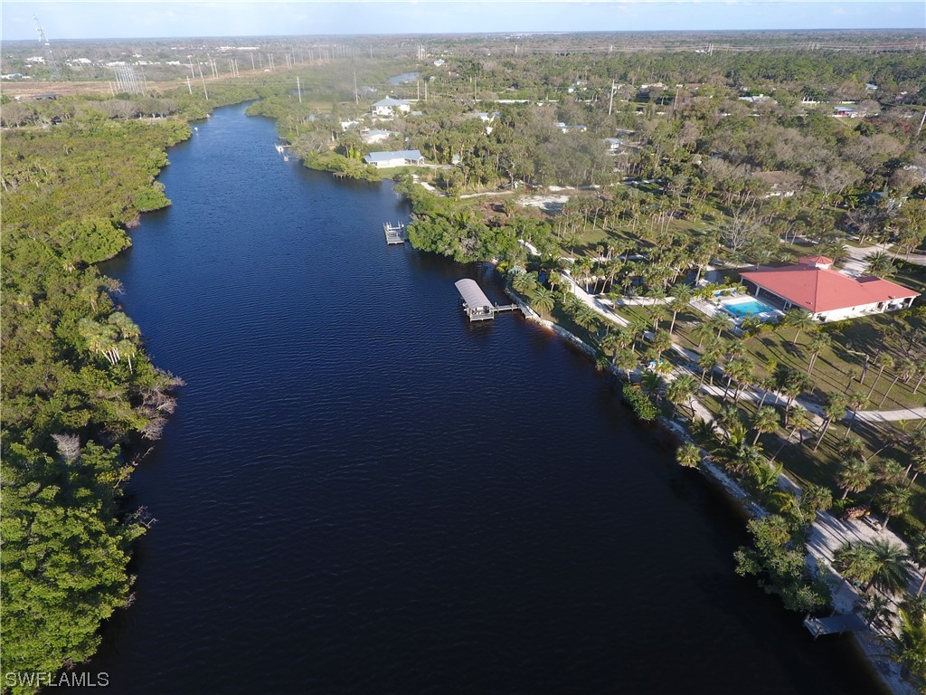 3860 Ellis Road Fort Myers, FL 33905 - Photo 13 of 18 an aerial view of lake and residential houses with outdoor space