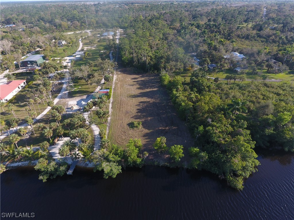 3860 Ellis Road Fort Myers, FL 33905 - Photo 14 of 18 a view of a lake with a building in the background