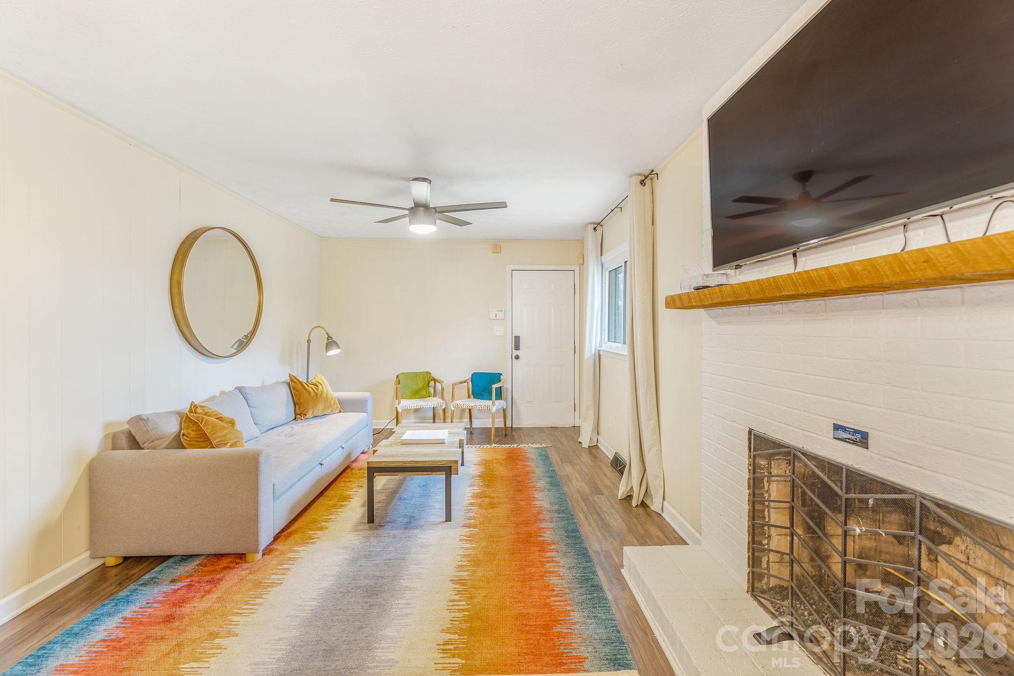 96 Oak Hill Road Candler, NC 28715 - Photo 14 of 41 a living room with furniture and a chandelier