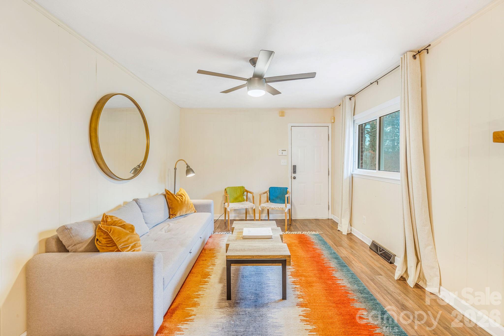 96 Oak Hill Road Candler, NC 28715 - Photo 15 of 41 a living room with furniture and a large window