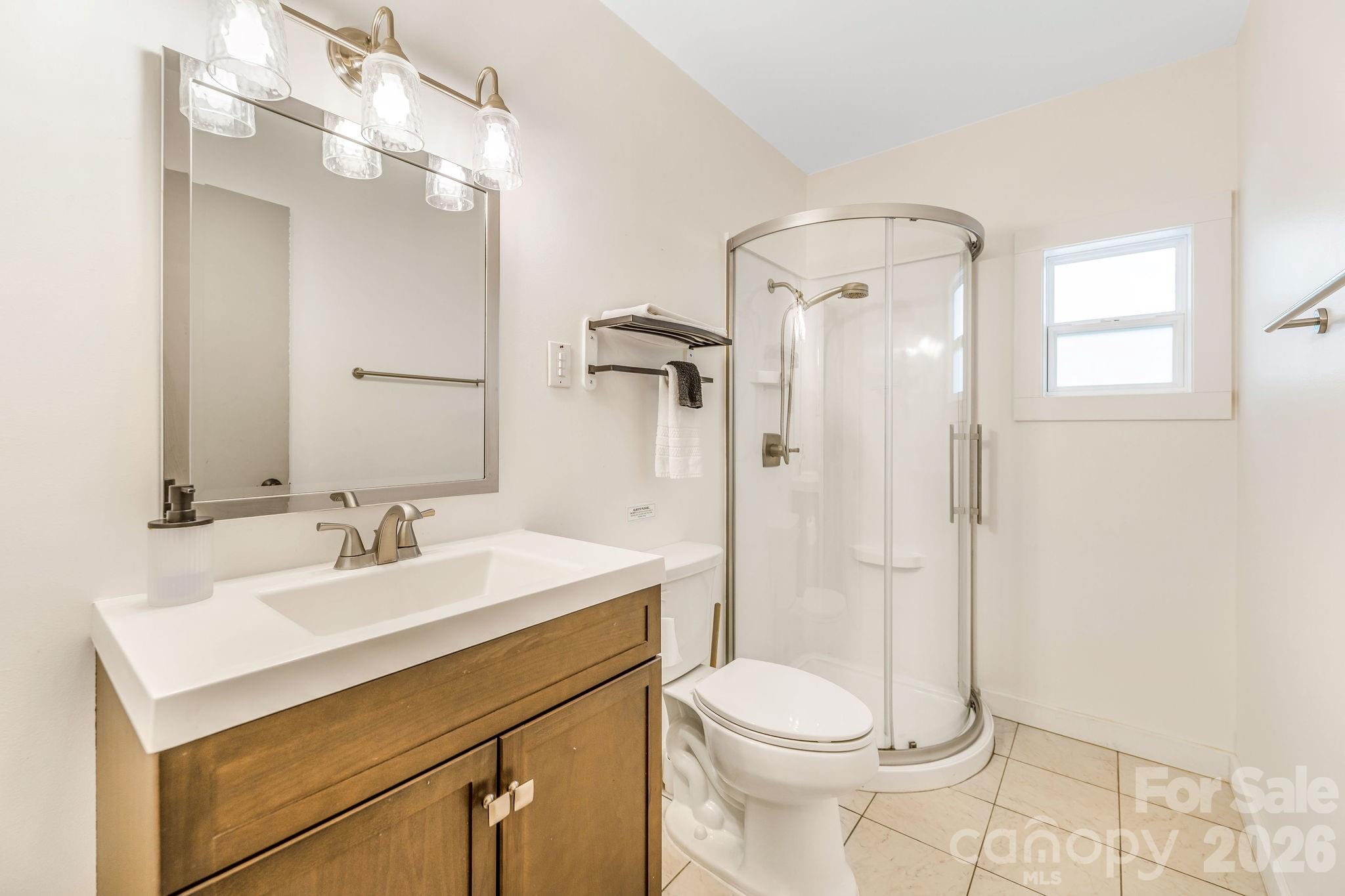 96 Oak Hill Road Candler, NC 28715 - Photo 18 of 41 a bathroom with a sink a toilet and shower