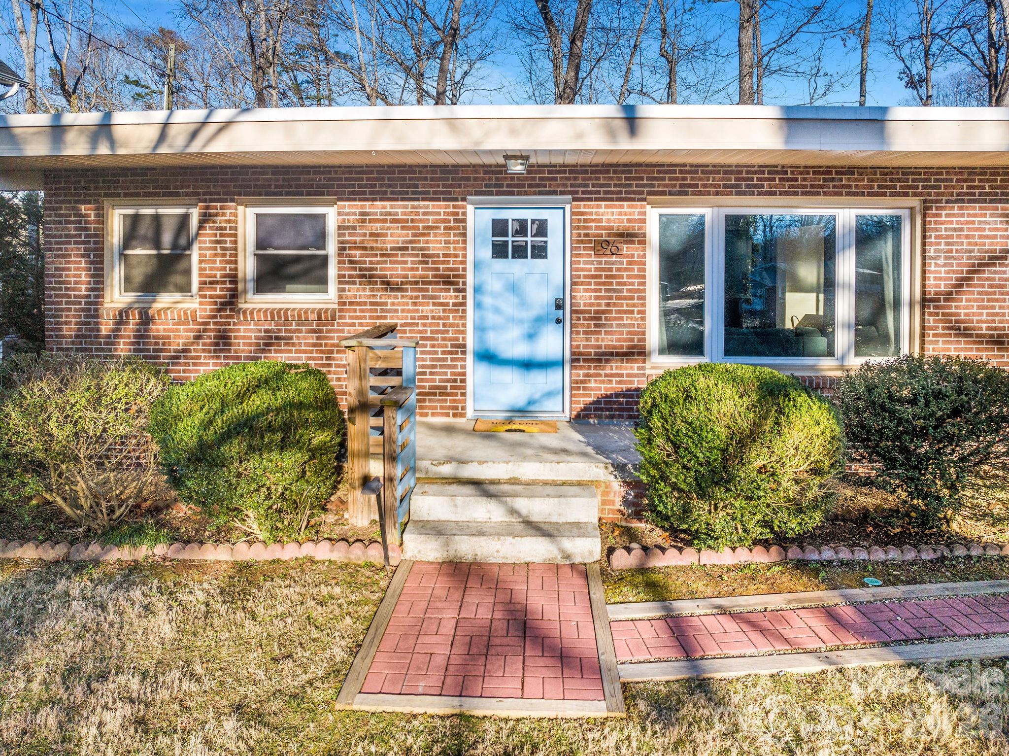 96 Oak Hill Road Candler, NC 28715 - Photo 2 of 41 a front view of a house with a yard