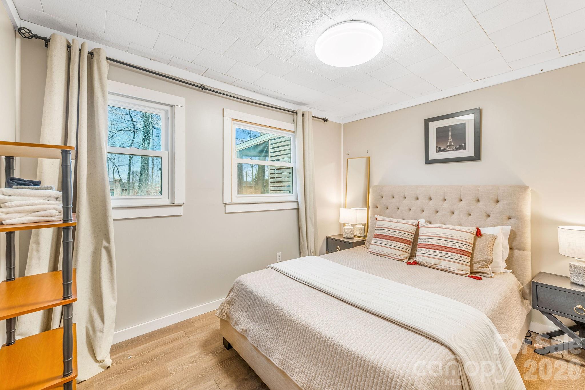 96 Oak Hill Road Candler, NC 28715 - Photo 21 of 41 a bedroom with a bed and a window