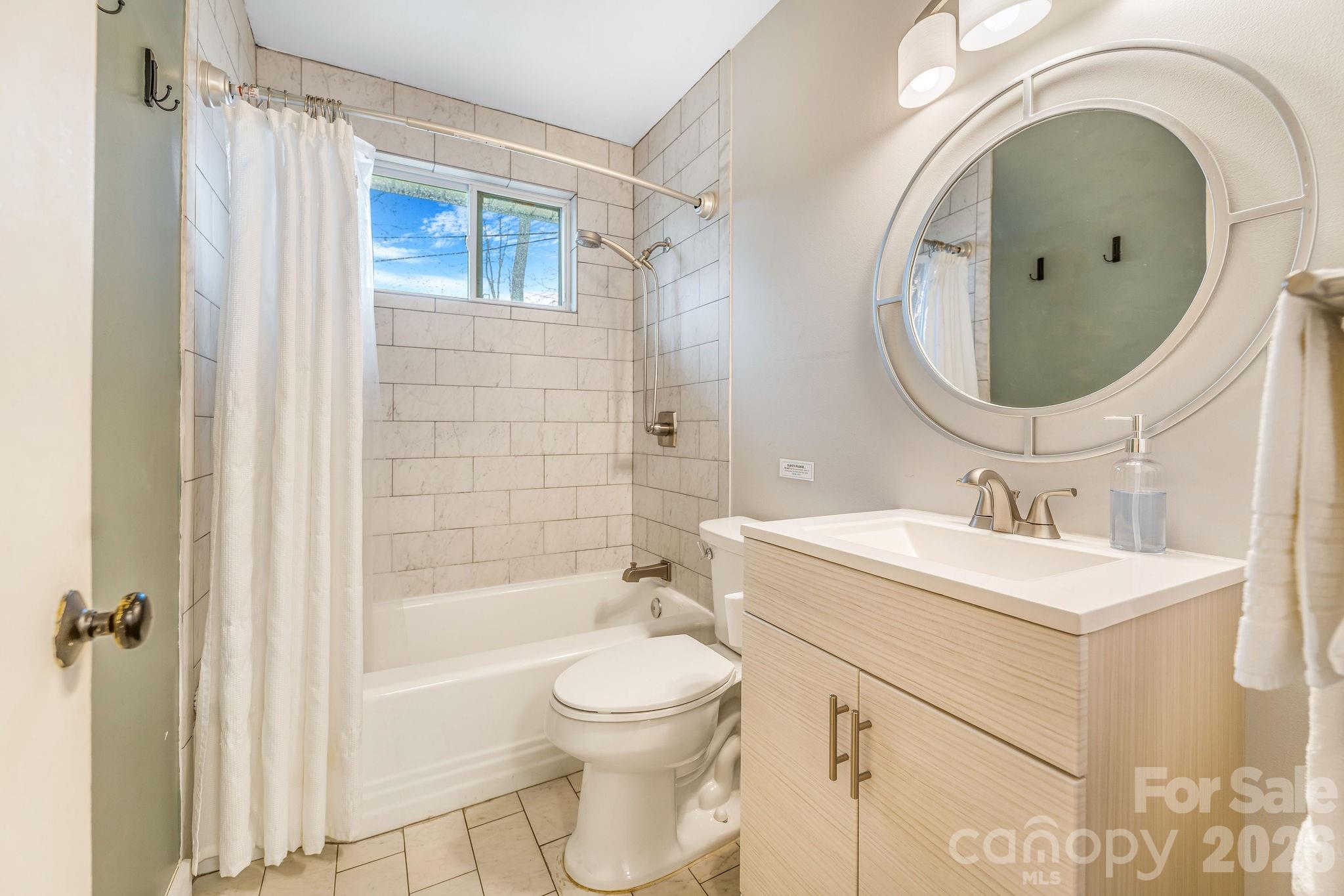 96 Oak Hill Road Candler, NC 28715 - Photo 22 of 41 a bathroom with a sink toilet and shower