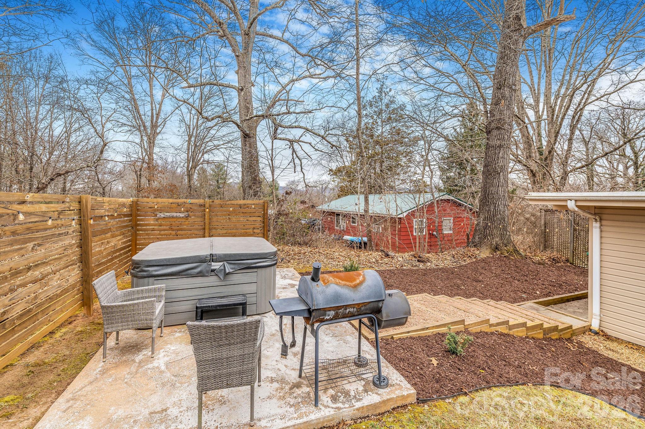 96 Oak Hill Road Candler, NC 28715 - Photo 34 of 41 a backyard of a house with table and chairs