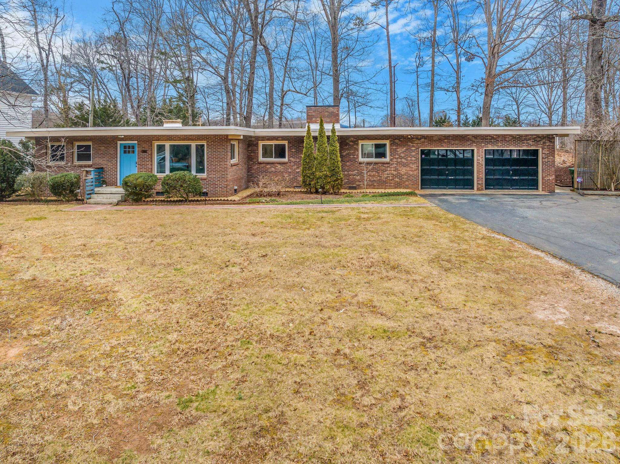 96 Oak Hill Road Candler, NC 28715 - Photo 37 of 41 a front view of a building with yellow lighting