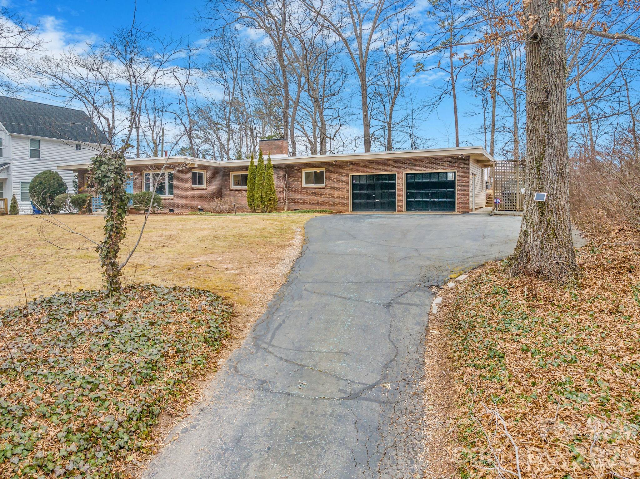 96 Oak Hill Road Candler, NC 28715 - Photo 39 of 41 a front view of a house with a yard and garage