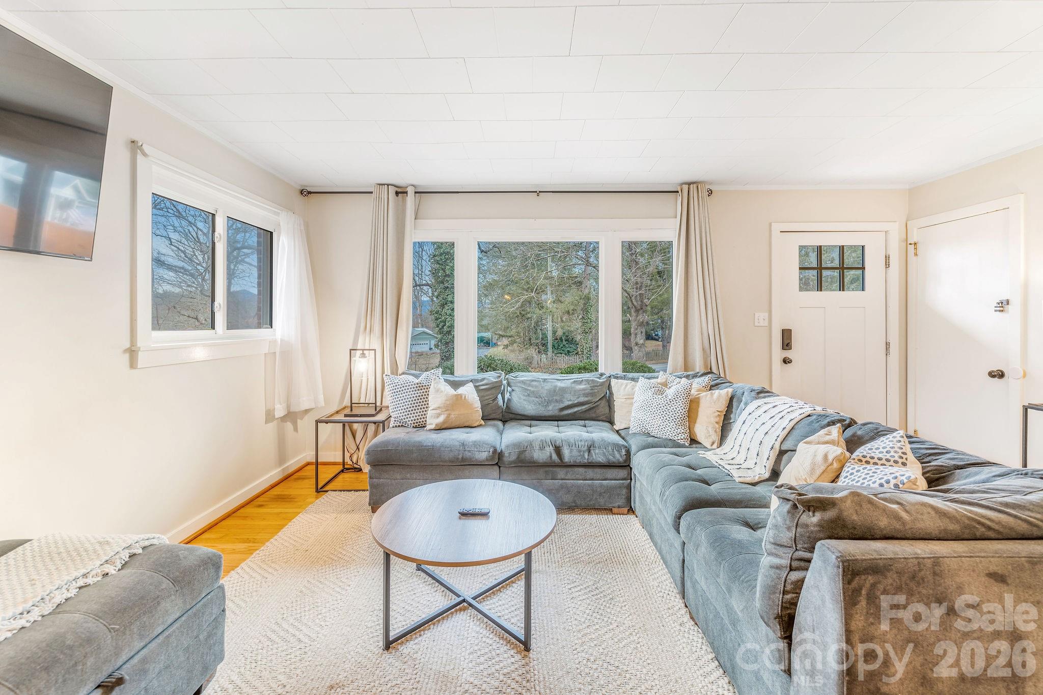 96 Oak Hill Road Candler, NC 28715 - Photo 7 of 41 a living room with furniture and a large window