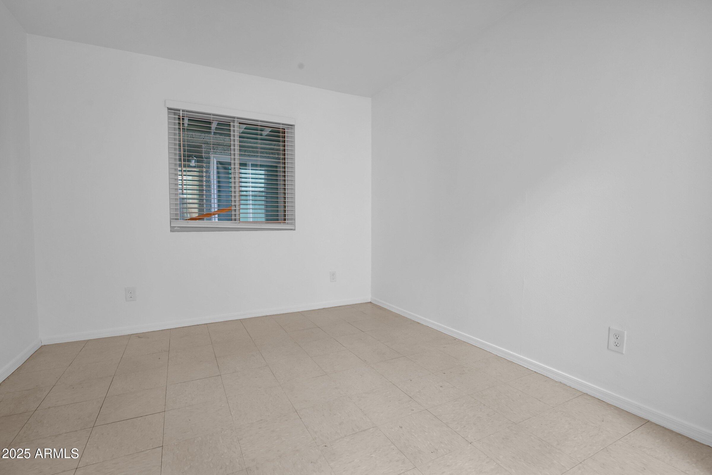 2234 West Hazelwood Street Phoenix, AZ 85015 - Photo 14 of 22 an empty room with a window