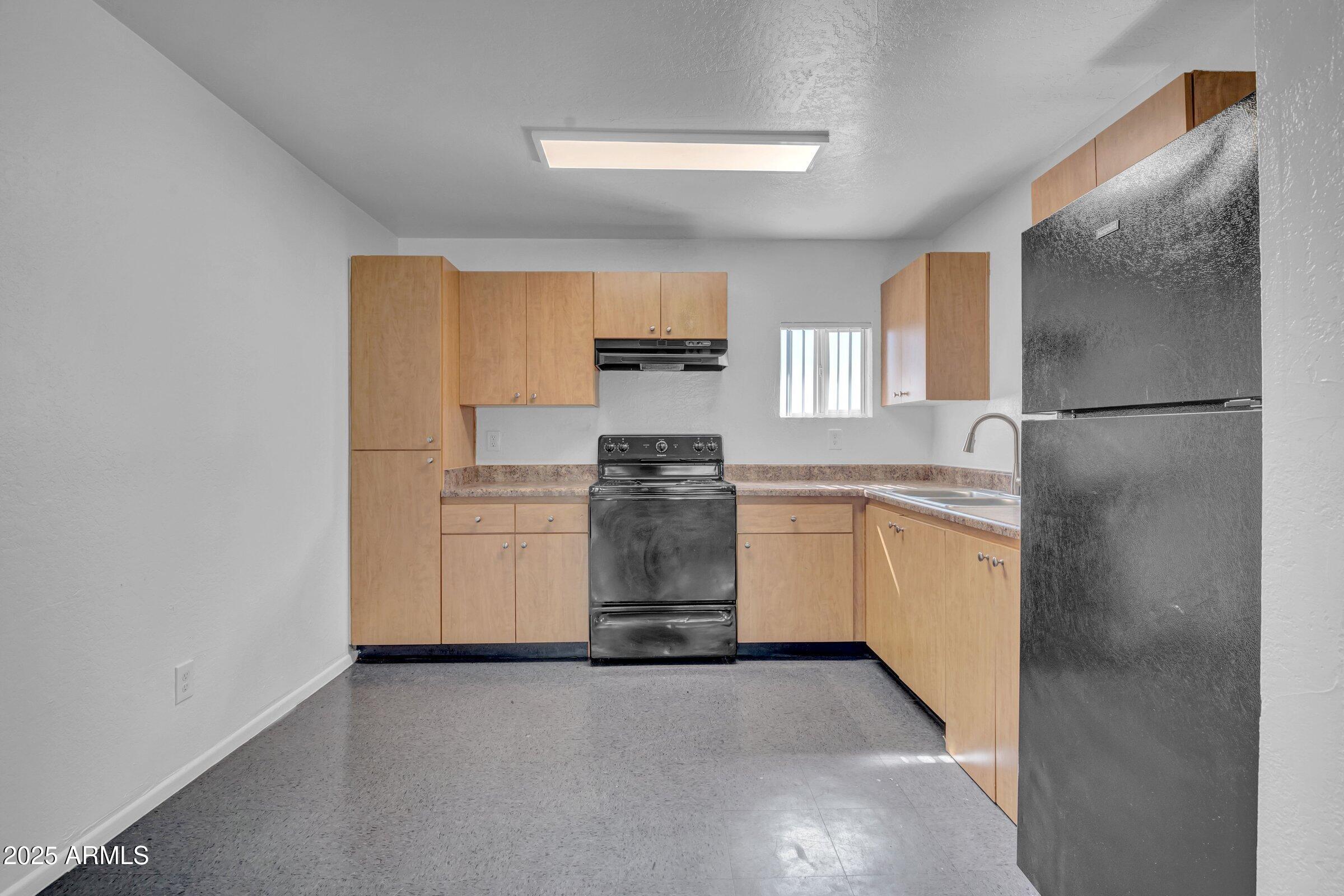 2234 West Hazelwood Street Phoenix, AZ 85015 - Photo 16 of 22 a kitchen with a refrigerator and a stove