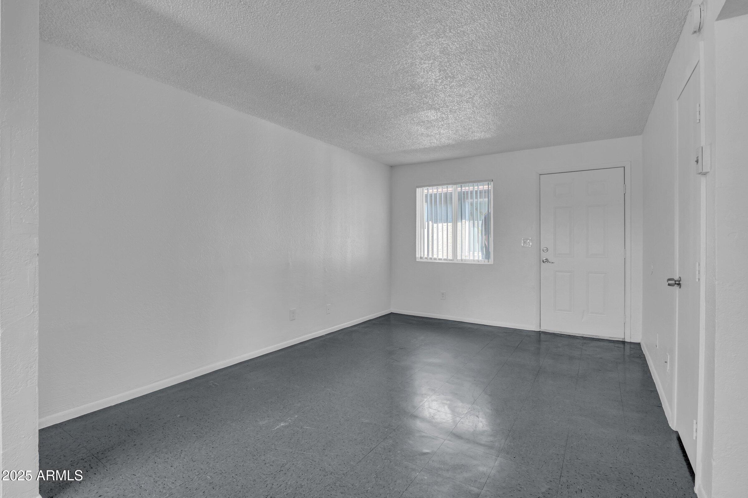 2234 West Hazelwood Street Phoenix, AZ 85015 - Photo 18 of 22 an empty room with windows