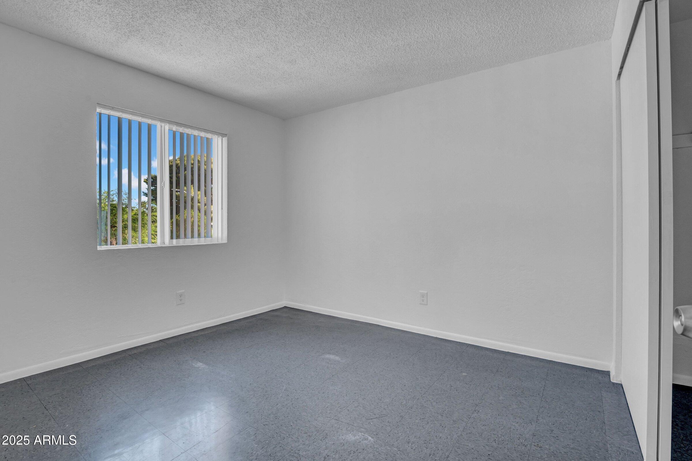 2234 West Hazelwood Street Phoenix, AZ 85015 - Photo 20 of 22 an empty room with a window