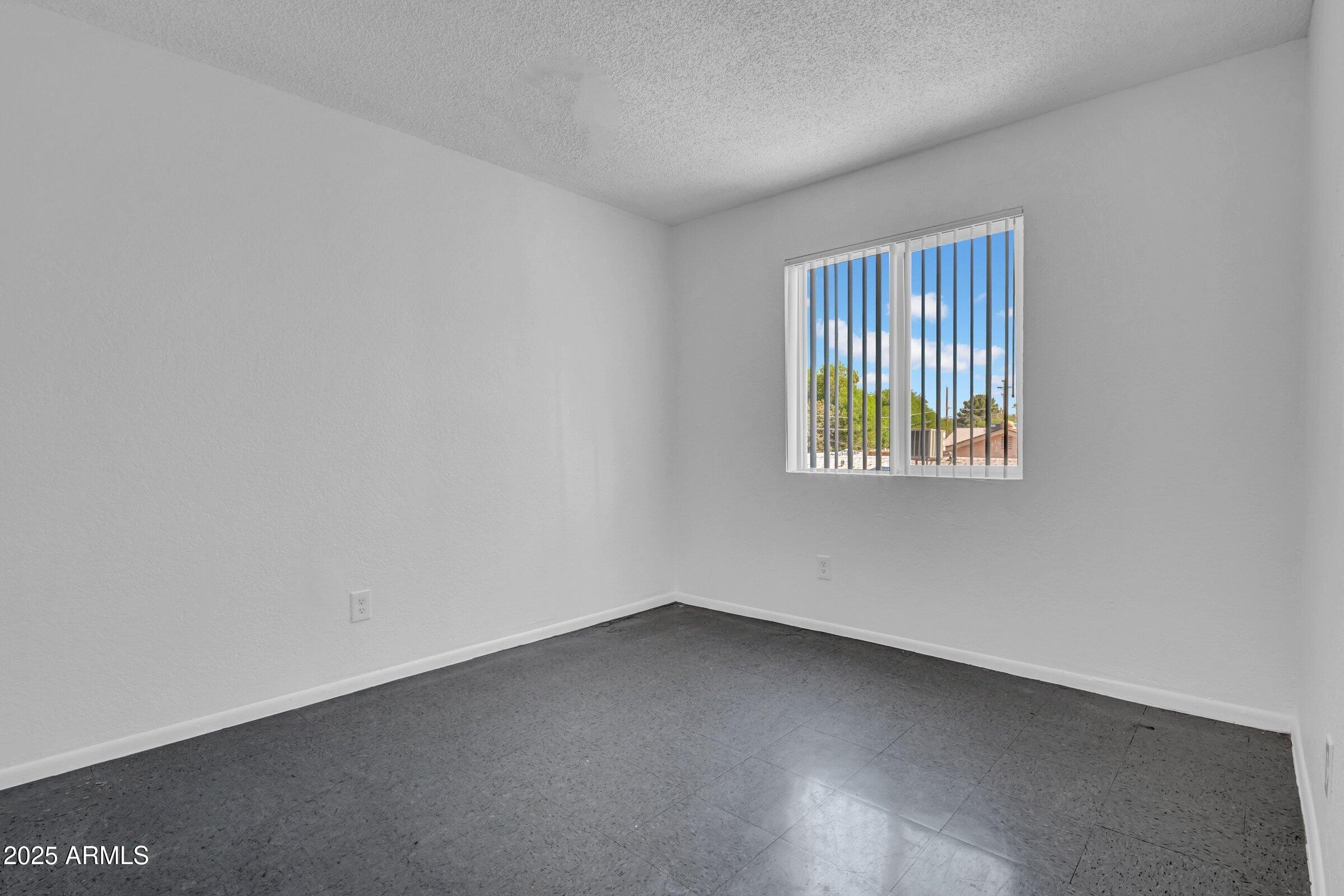 2234 West Hazelwood Street Phoenix, AZ 85015 - Photo 21 of 22 an empty room with a window