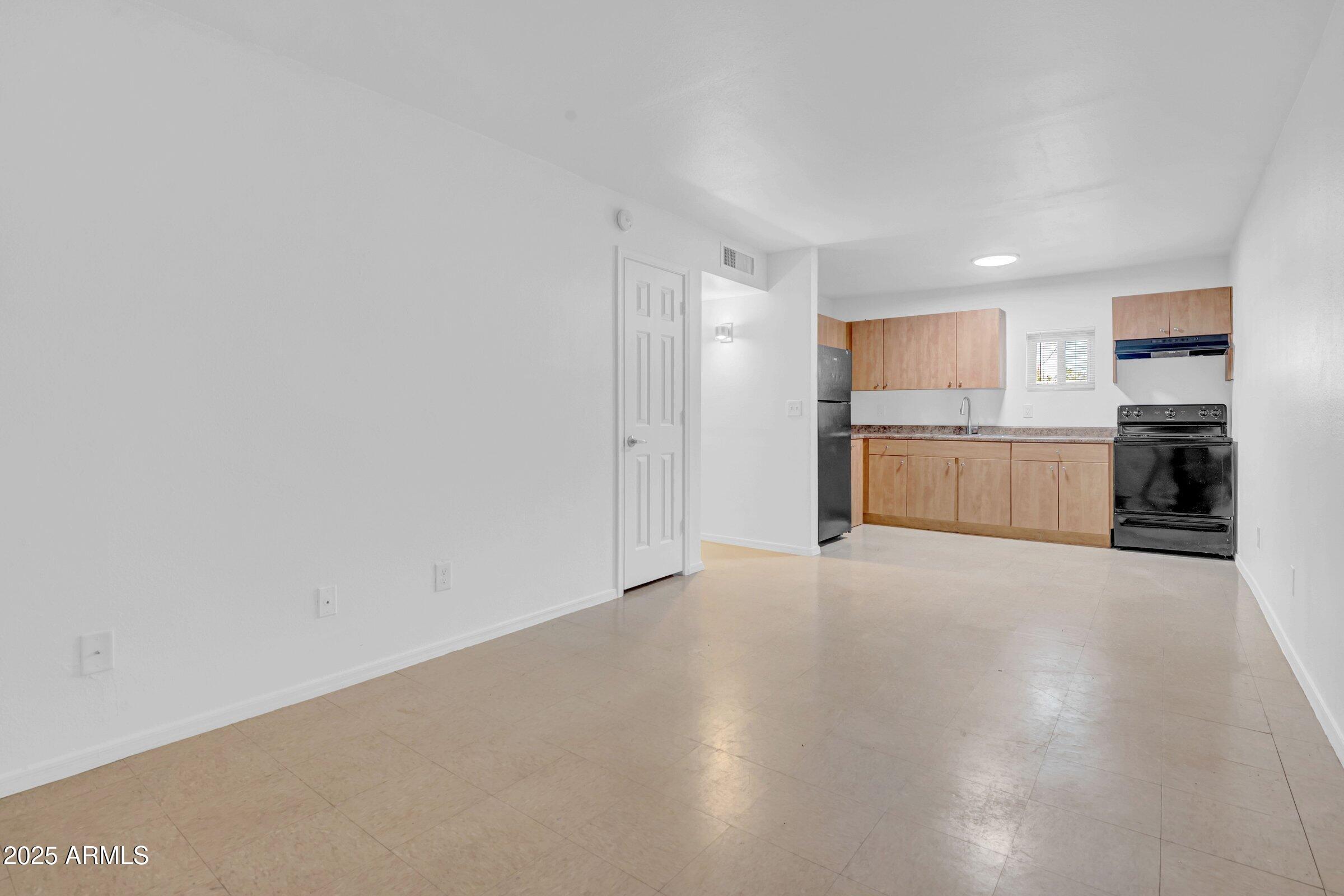 2234 West Hazelwood Street Phoenix, AZ 85015 - Photo 9 of 22 a view of a kitchen with a sink and a refrigerator