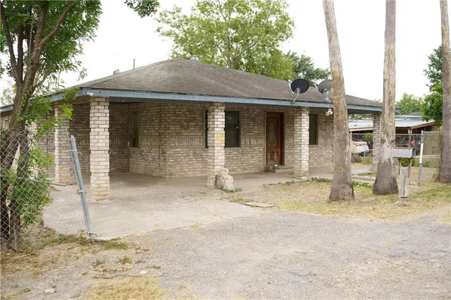 a view of a house with backyard porch and sitting area