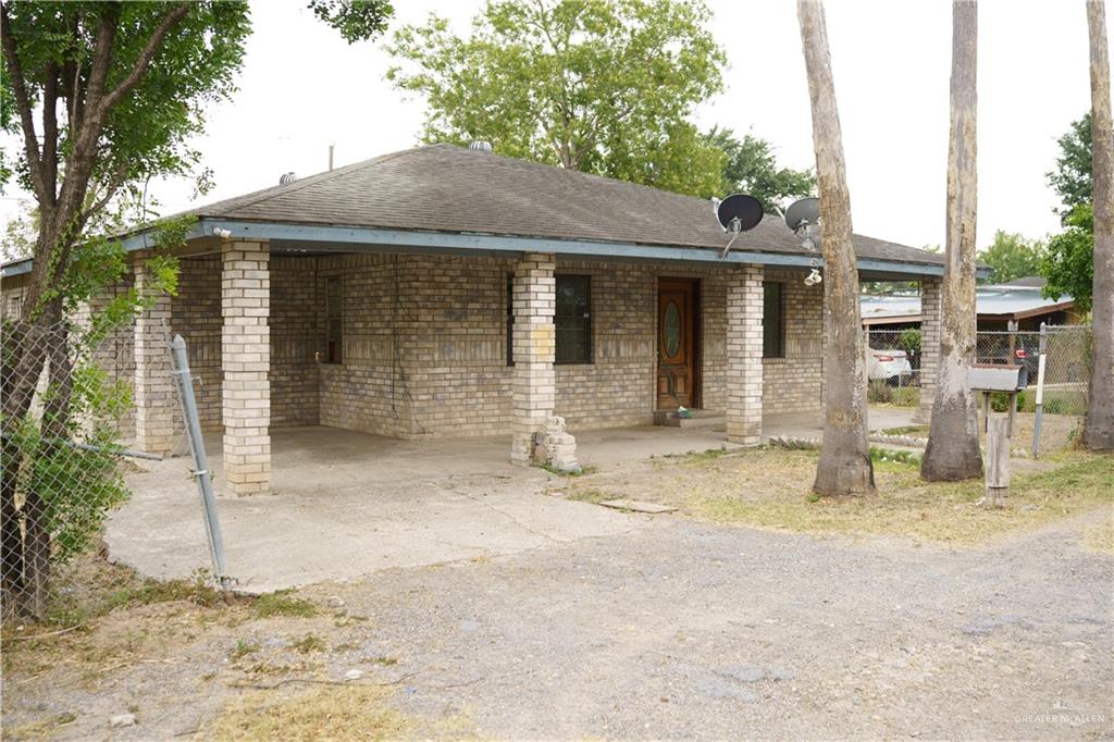a view of a house with backyard porch and sitting area