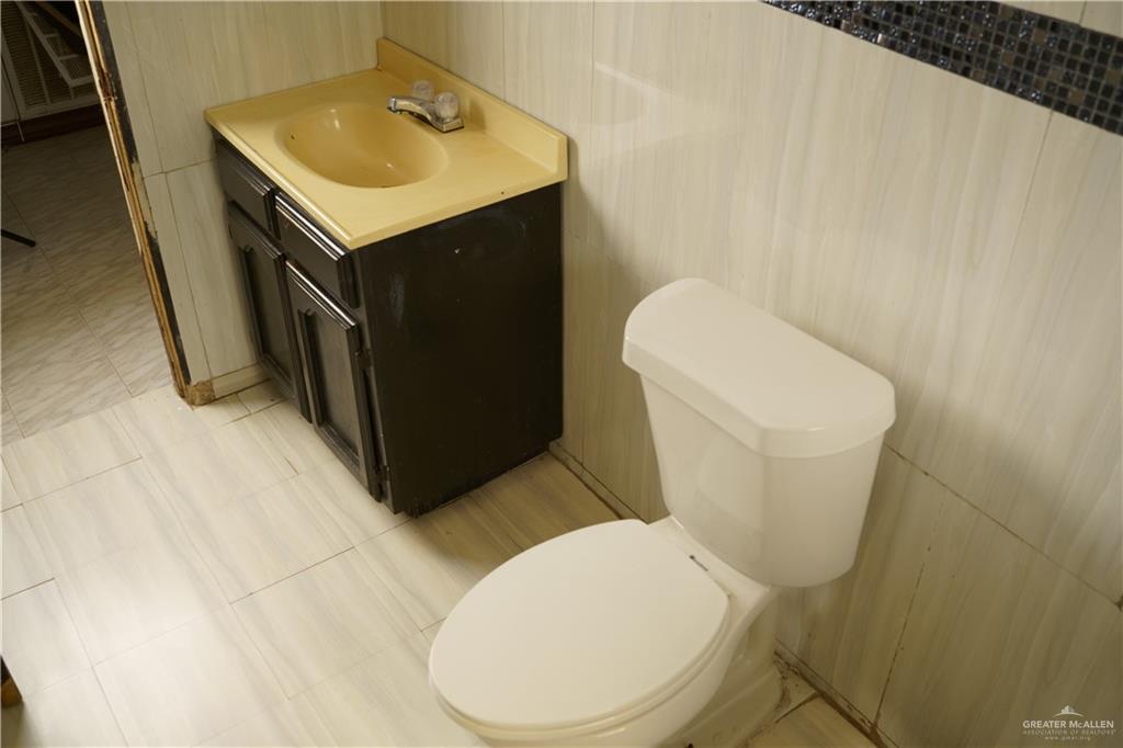 5909 Kountry Loop Mission, TX 78574 - Photo 14 of 23 a white toilet sitting next to a white sink