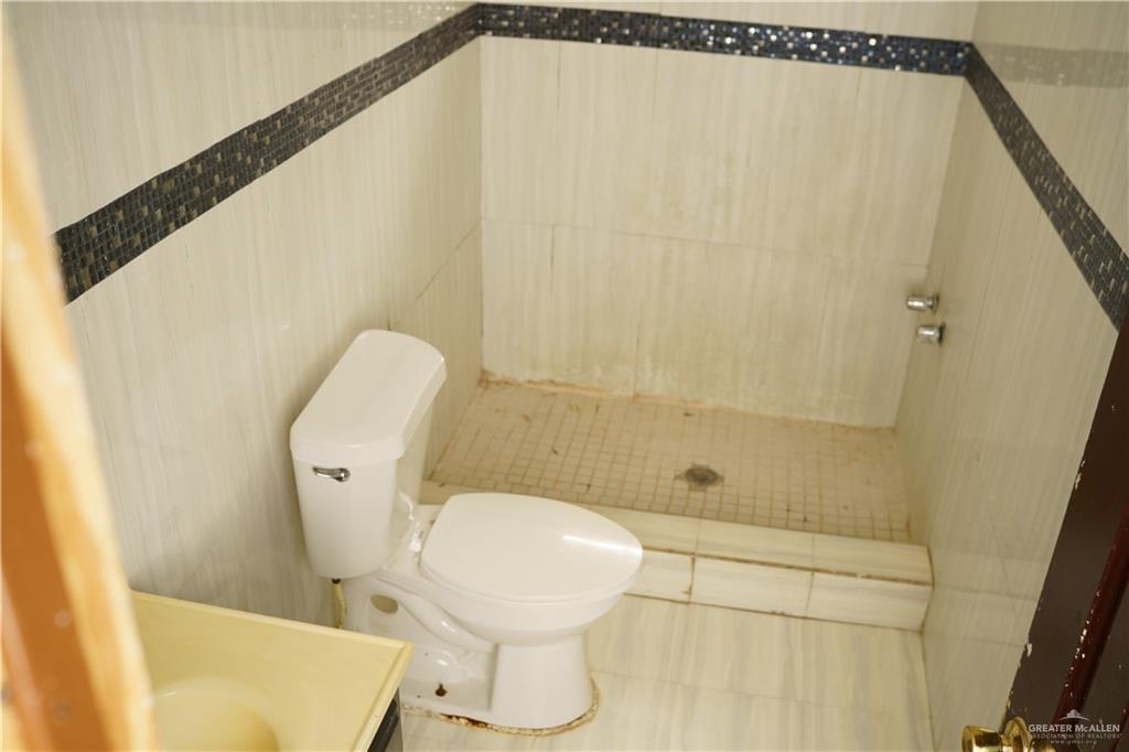 5909 Kountry Loop Mission, TX 78574 - Photo 15 of 23 a bathroom with a toilet and a shower