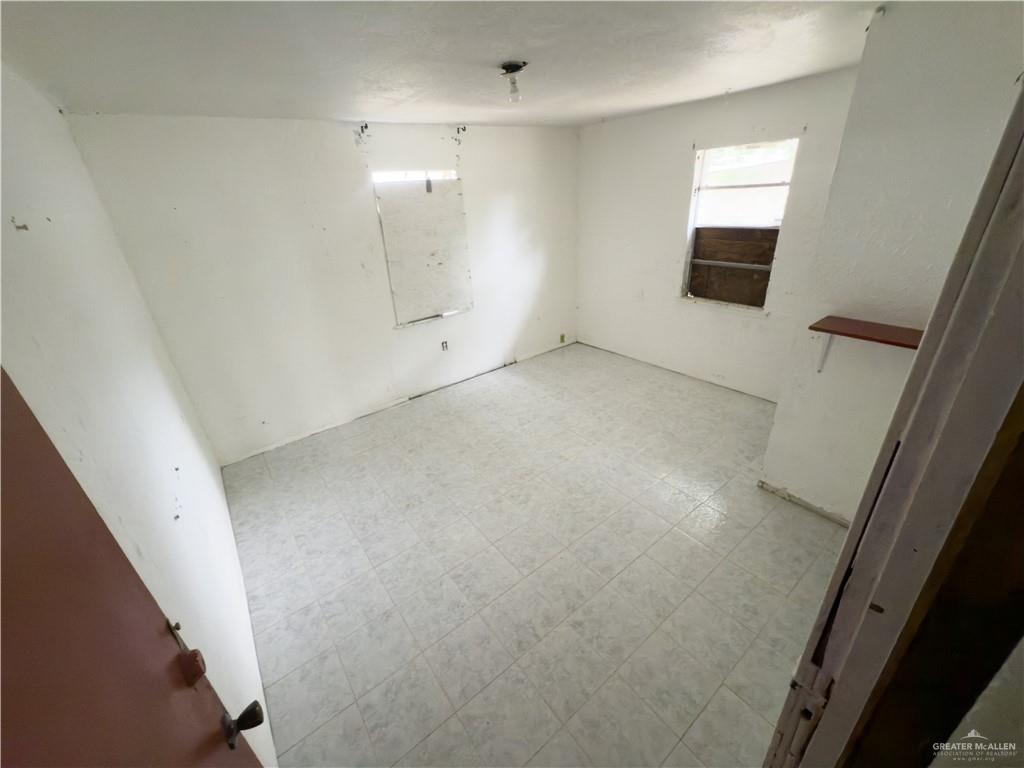 5909 Kountry Loop Mission, TX 78574 - Photo 20 of 23 wooden floor in an empty room with a window