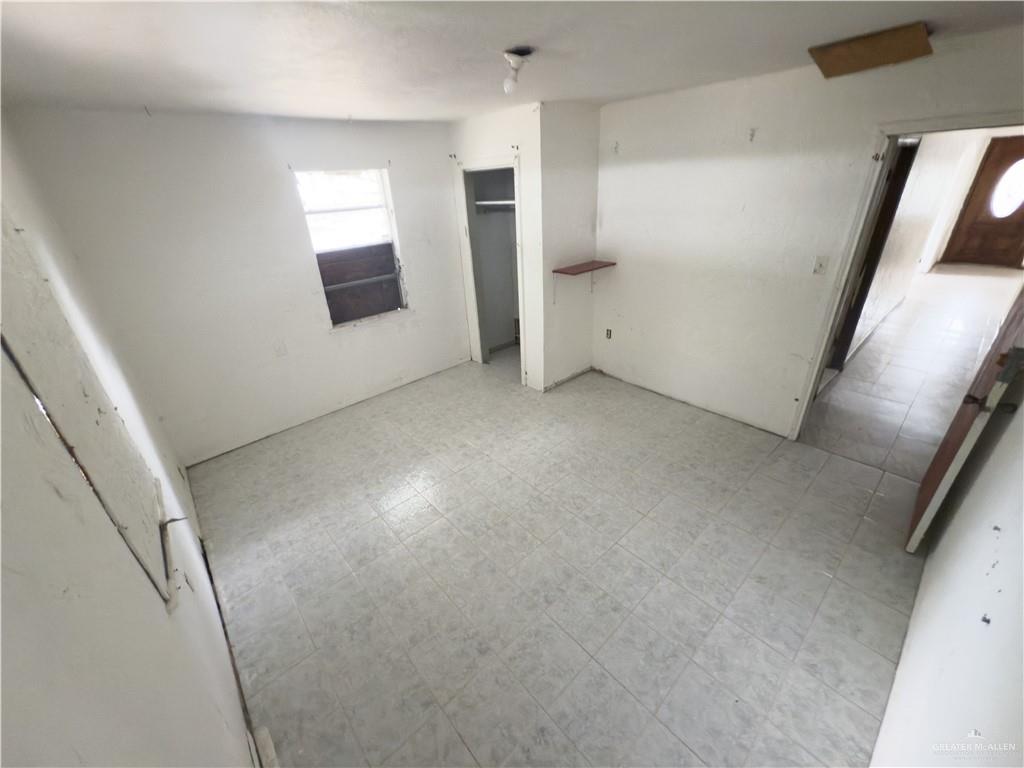 5909 Kountry Loop Mission, TX 78574 - Photo 21 of 23 en empty room with windows and fireplace