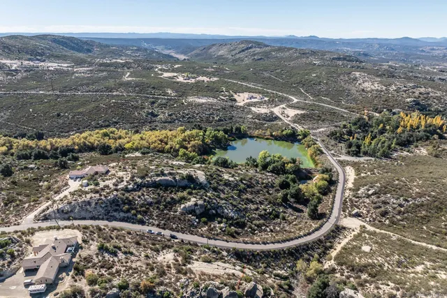an aerial view of mountain with yard