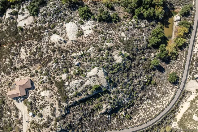 an aerial view of residential houses with outdoor space