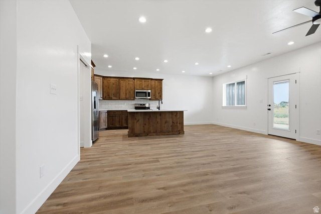 164 North 400 East Preston, ID 83263 - Photo 3 of 21 Open-concept living space featuring wood-finish flooring, recessed lighting, and a modern kitchen