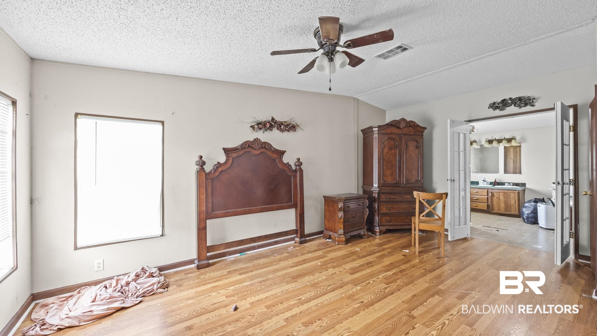 34985b Spring Road South, Unit B Stapleton, AL 36578 - Photo 21 of 31 Spacious room featuring wood-finish flooring, multiple windows with blinds, and a ceiling fan with integrated lighting