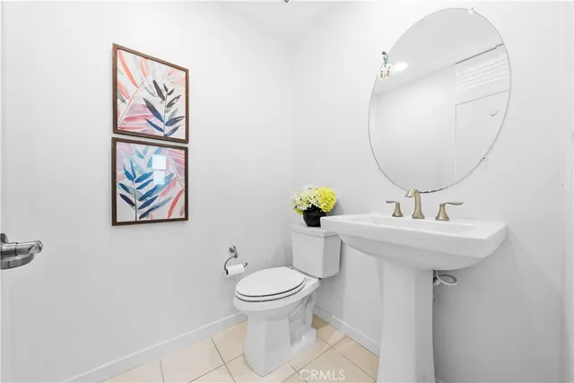 a kitchen with stainless steel appliances kitchen island granite countertop a stove a refrigerator a sink a dining table and chairs with wooden floor