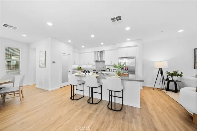 a living room with lots of furniture and kitchen view