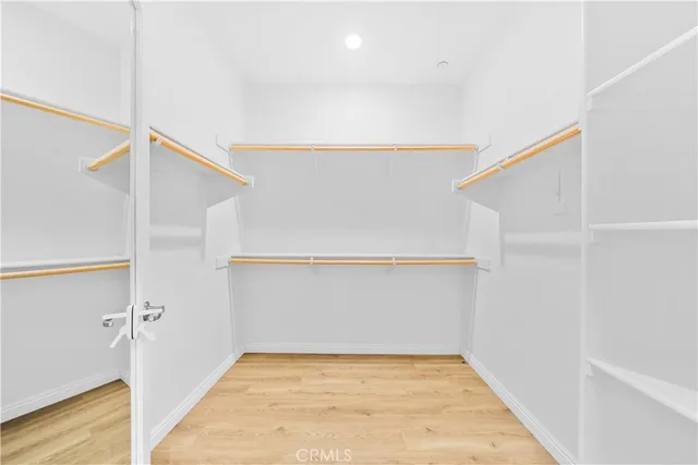 a spacious bathroom with a granite countertop sink a toilet a mirror and shower