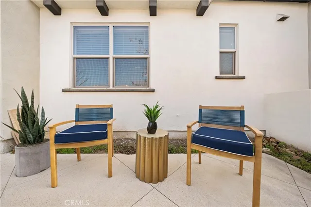a view of a room with wooden floor and a white door
