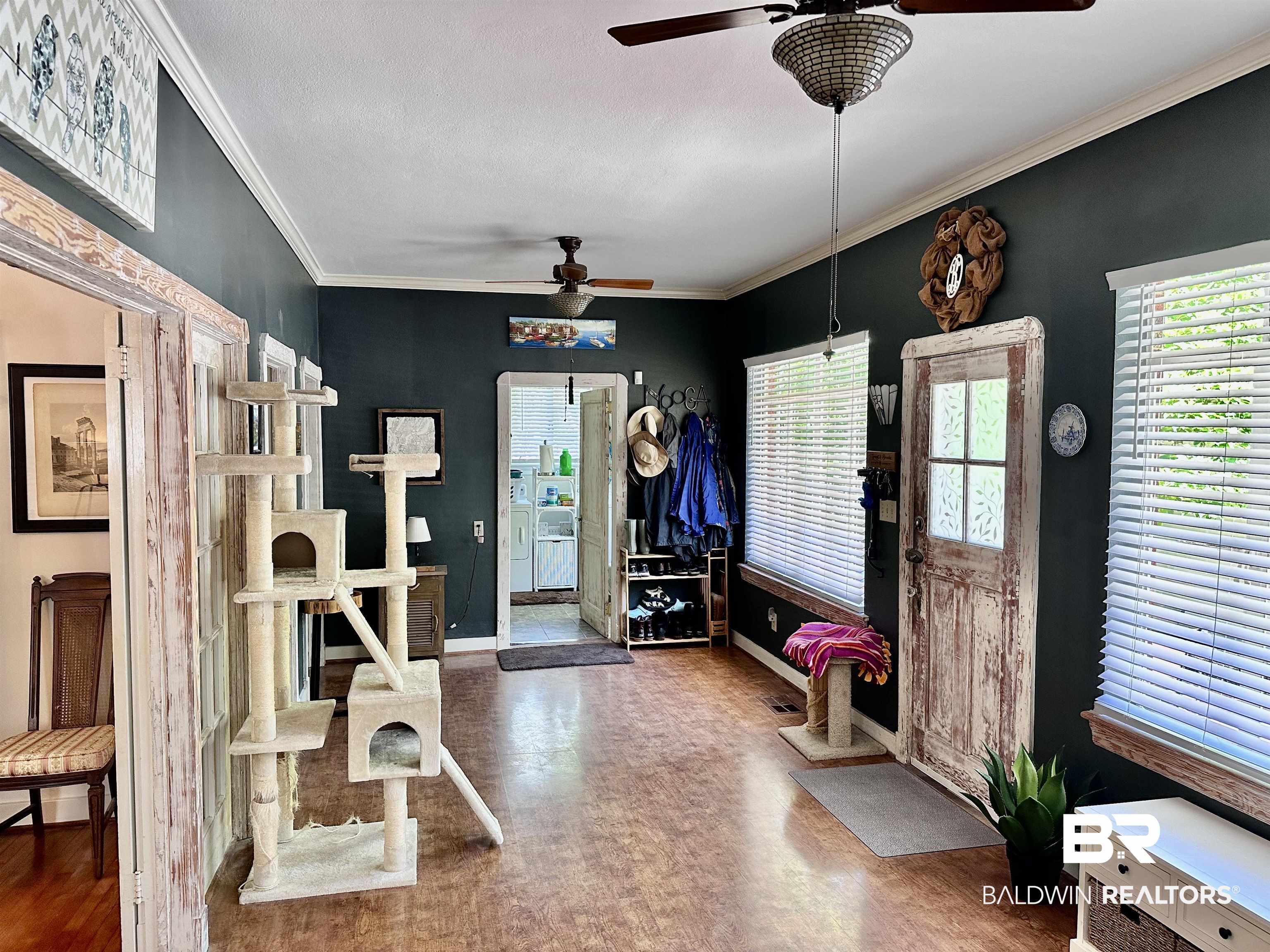 260 Siena Vista Street Mobile, AL 36607 - Photo 17 of 41 Foyer entrance featuring a ceiling fan, wood finished floors, baseboards, and crown molding