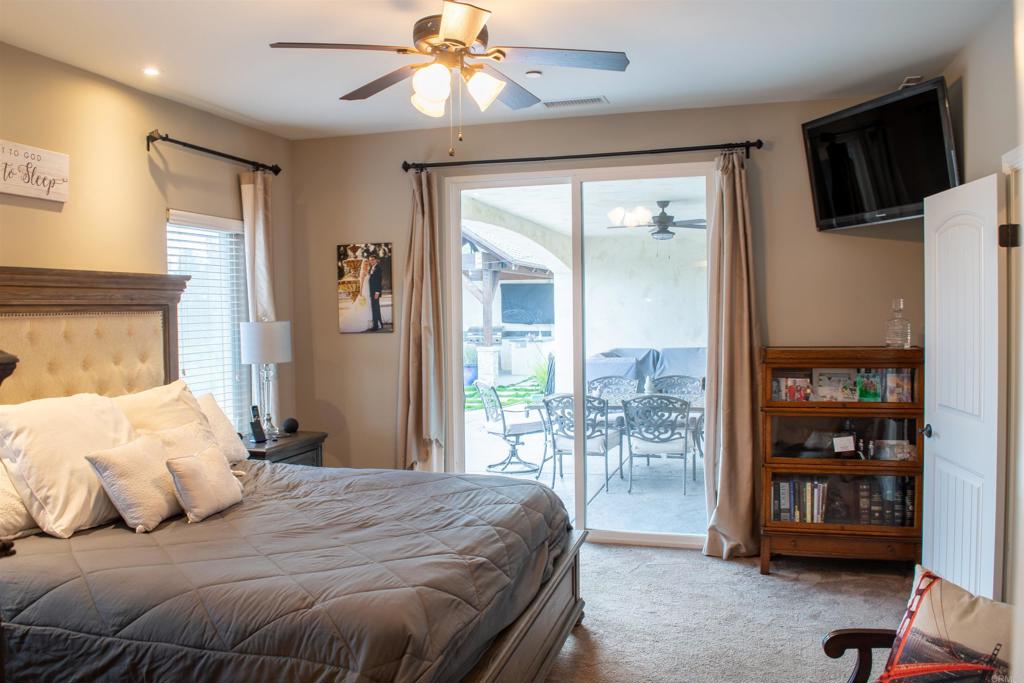 2521 Ralls Street Fallbrook, CA 92028 - Photo 5 of 43 a bedroom with a large bed and a tv