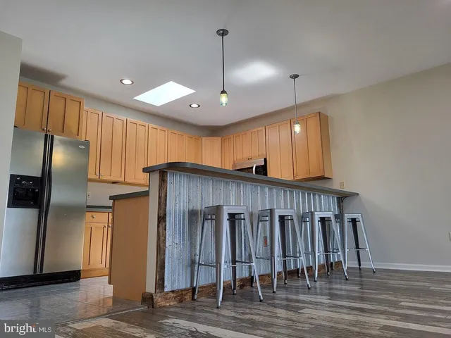 a bathroom with a granite countertop sink and a toilet